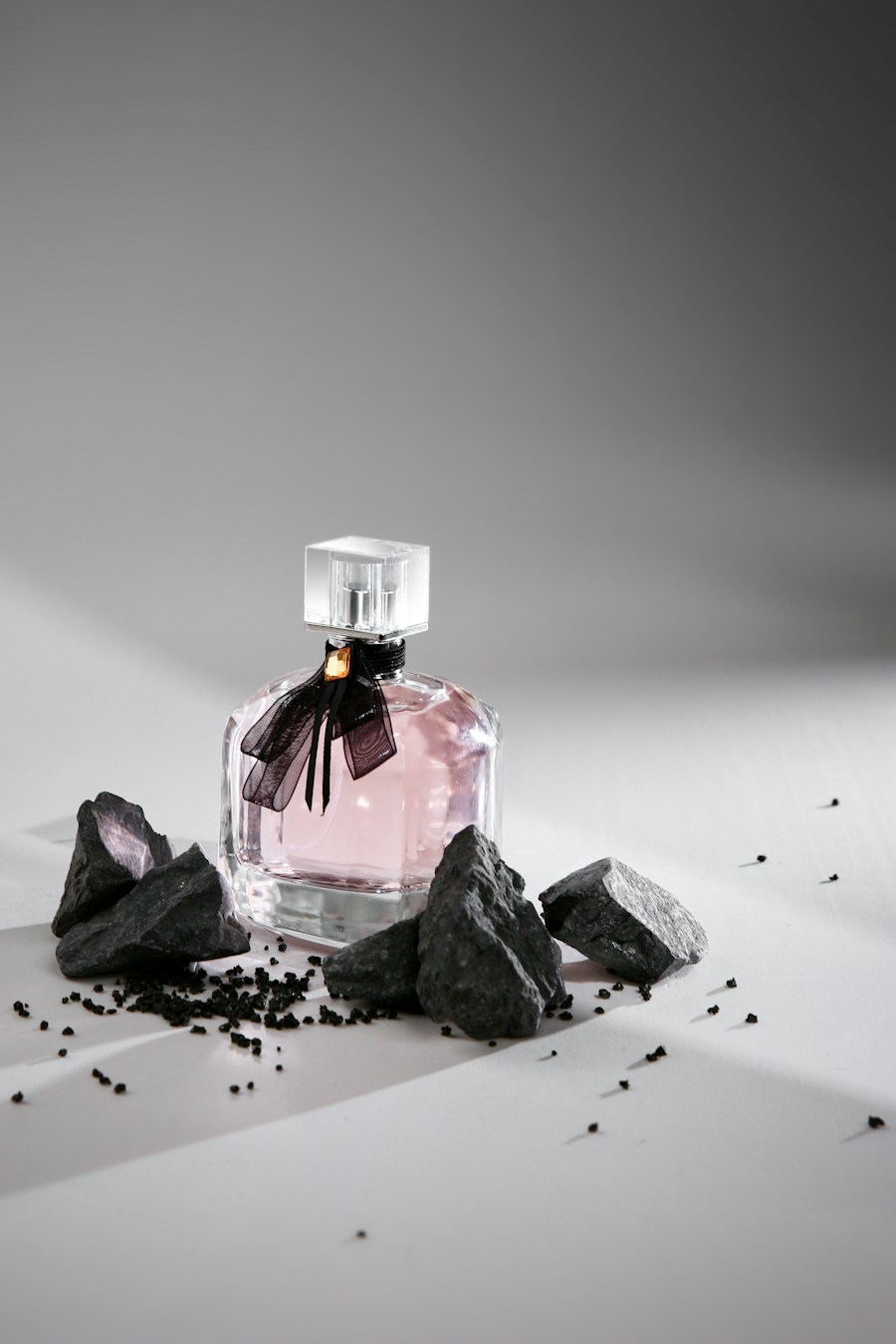 Perfume bottle on stones, editorial lighting