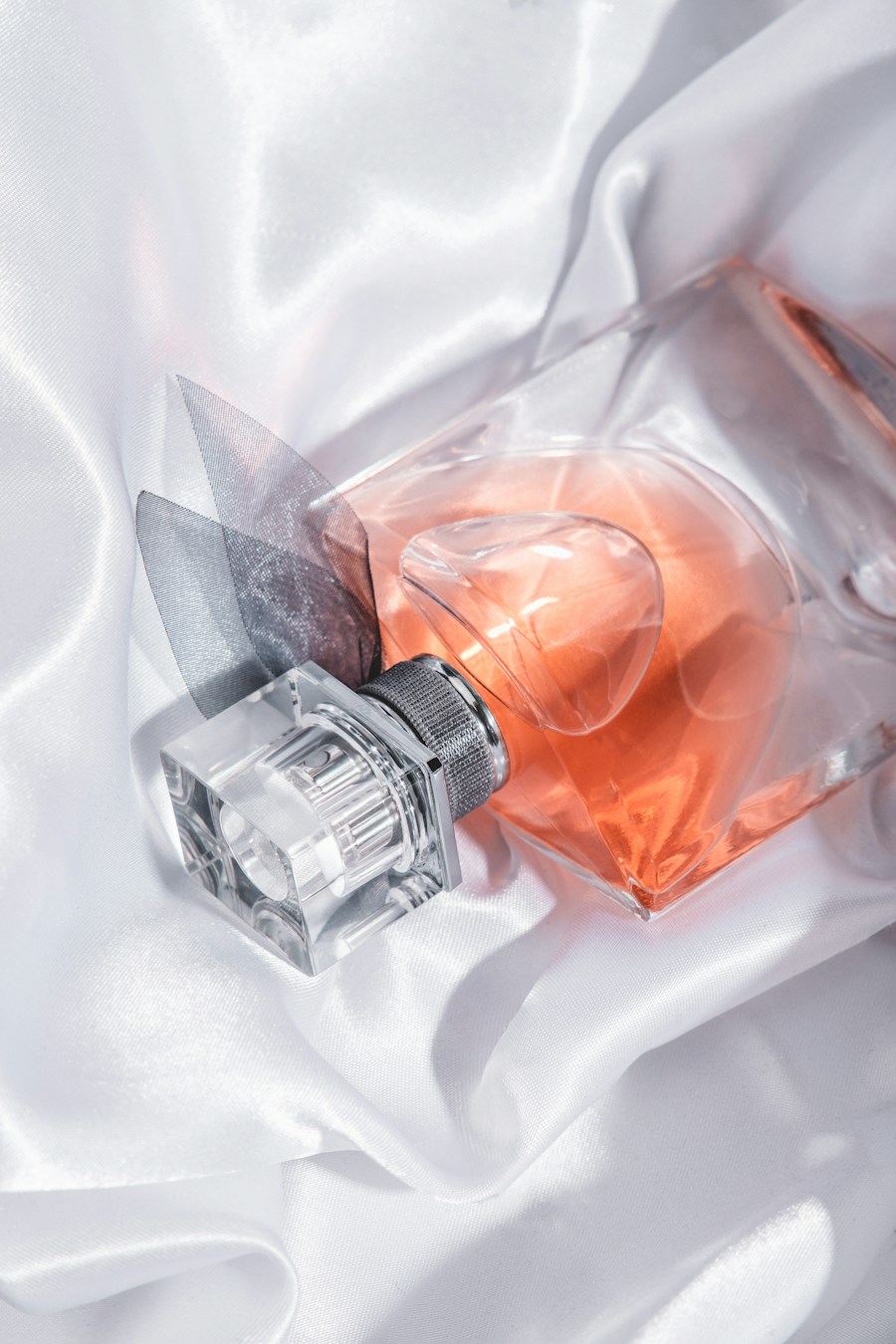 Glass perfume bottle on white textile